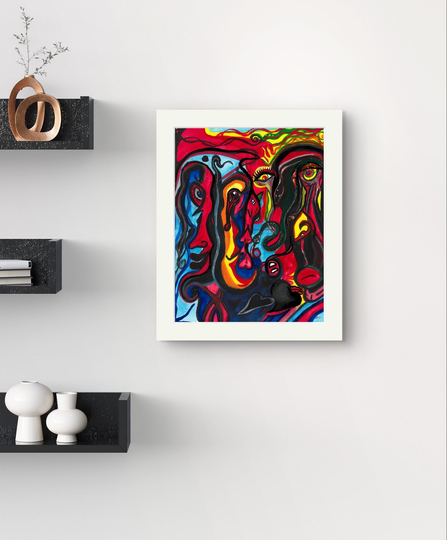 White bordered colorful face painting on white wall next to black bookshelves.