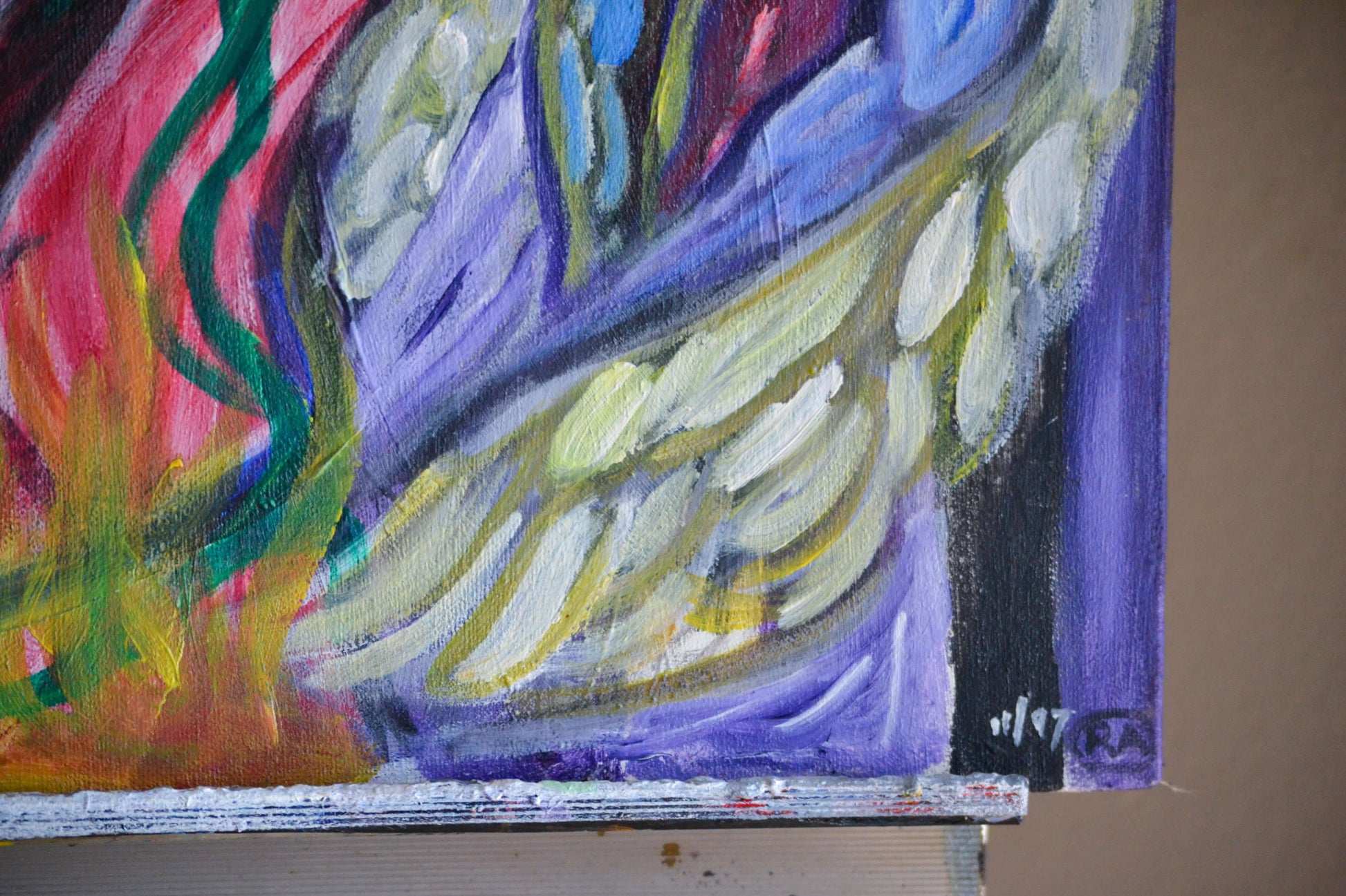 Closeup of artist signature and acrylic wing of angel.