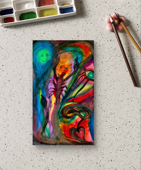 Watercolor painting on table next to paint palette.