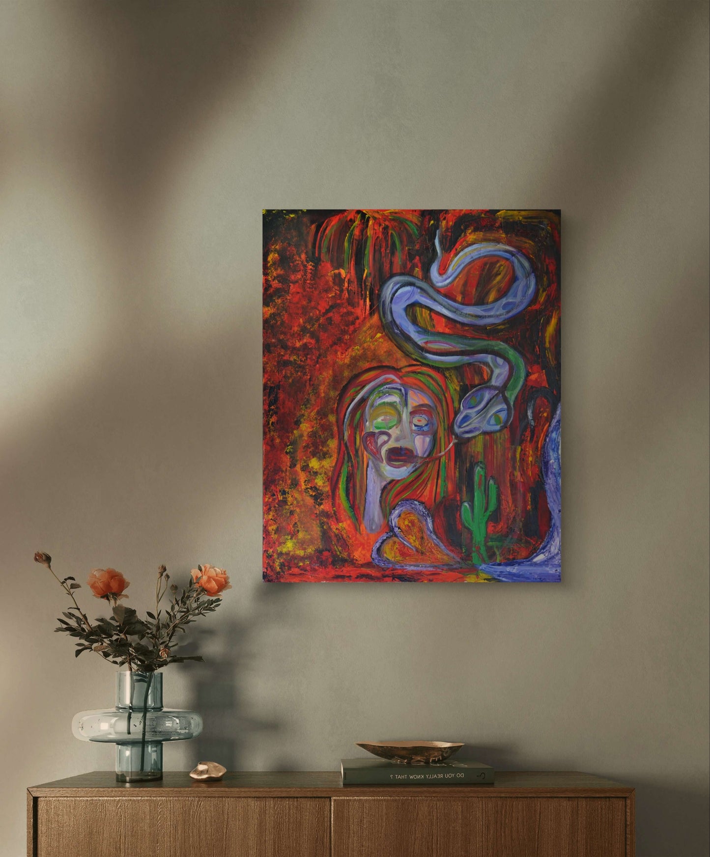 Red painting of distorted woman on green wall behind orange flowers above vinyl player.