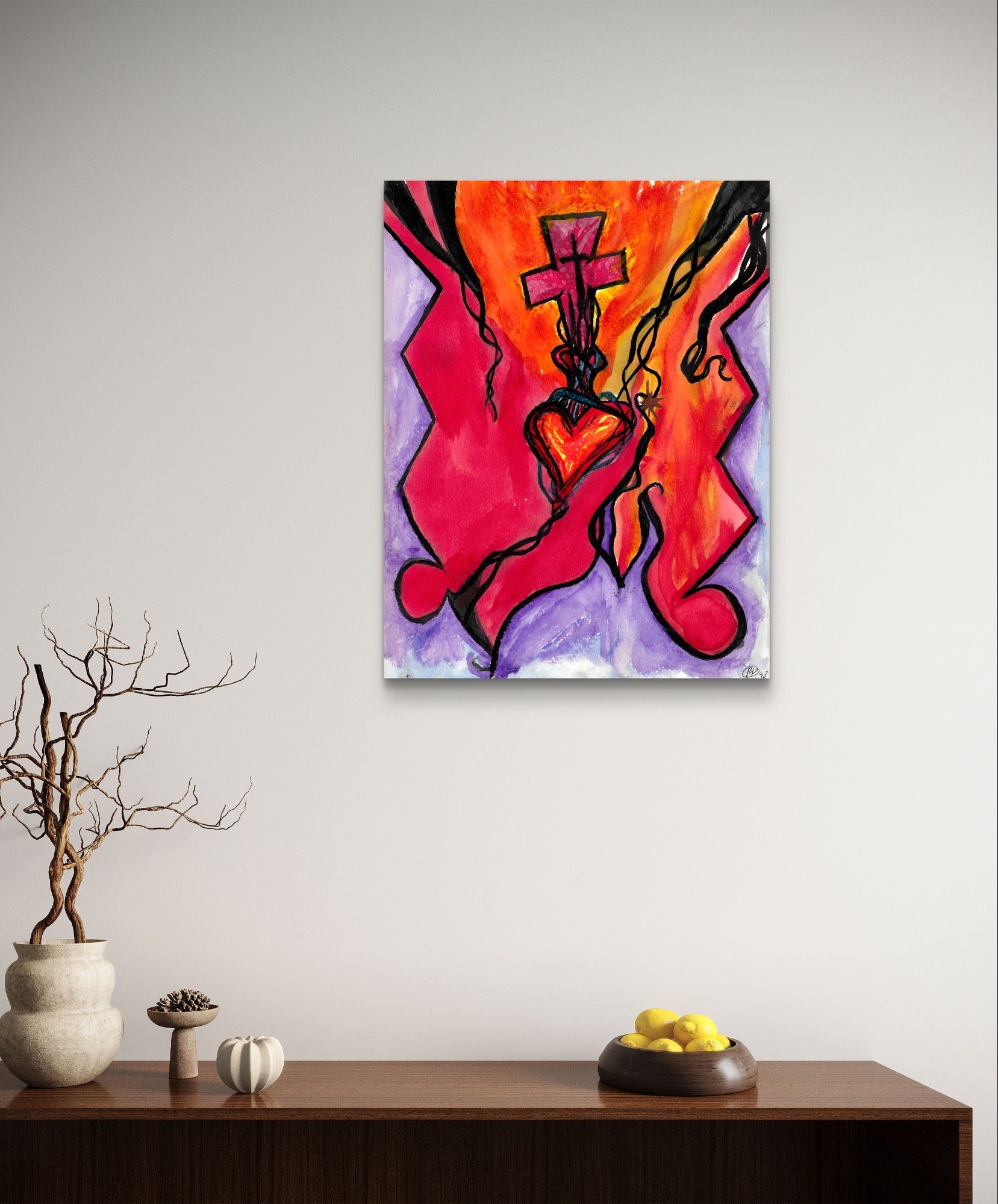 Orange heart cross painting on white wall above wooden table.