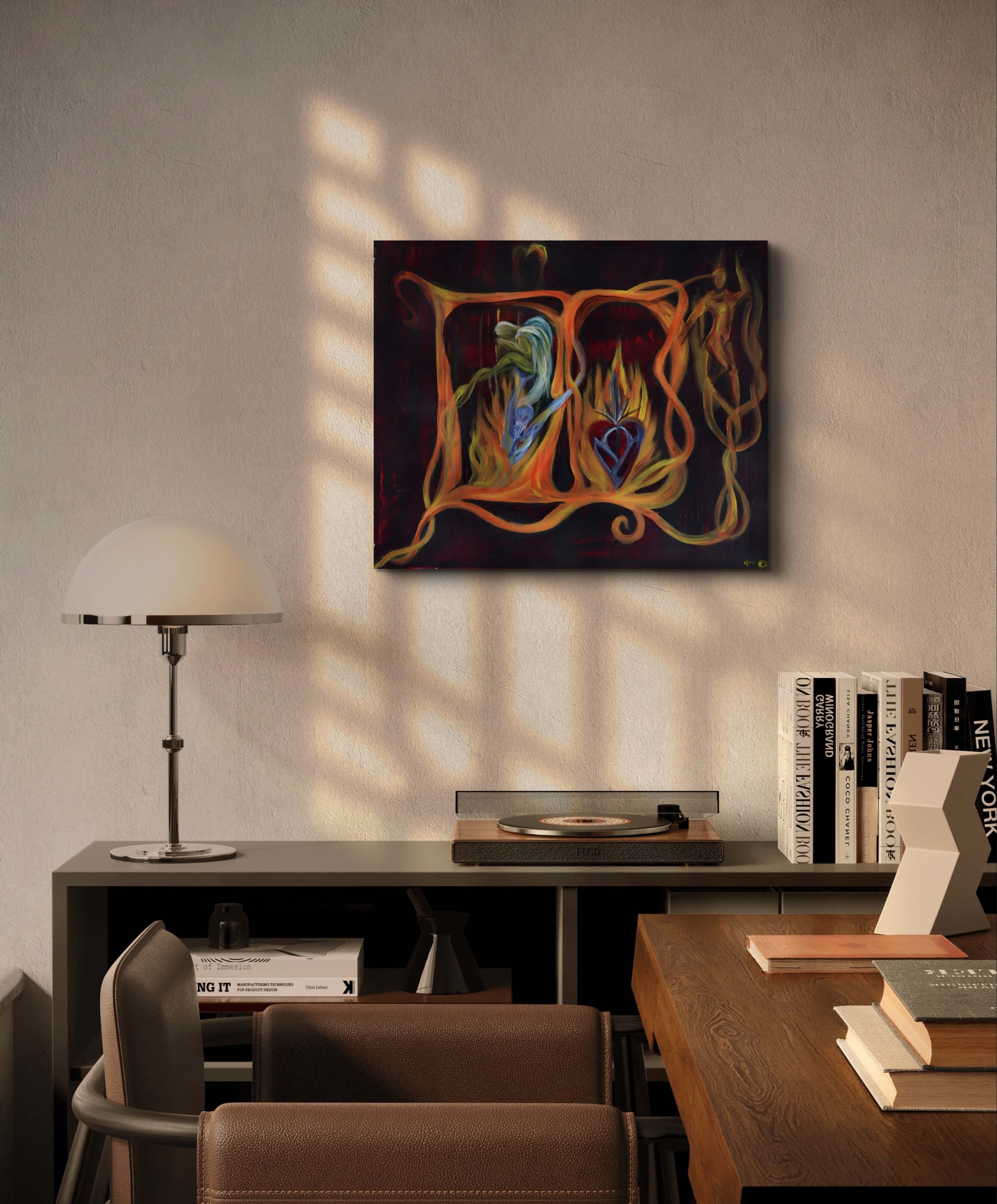 Orange painting on white wall above wooden table and lamp.