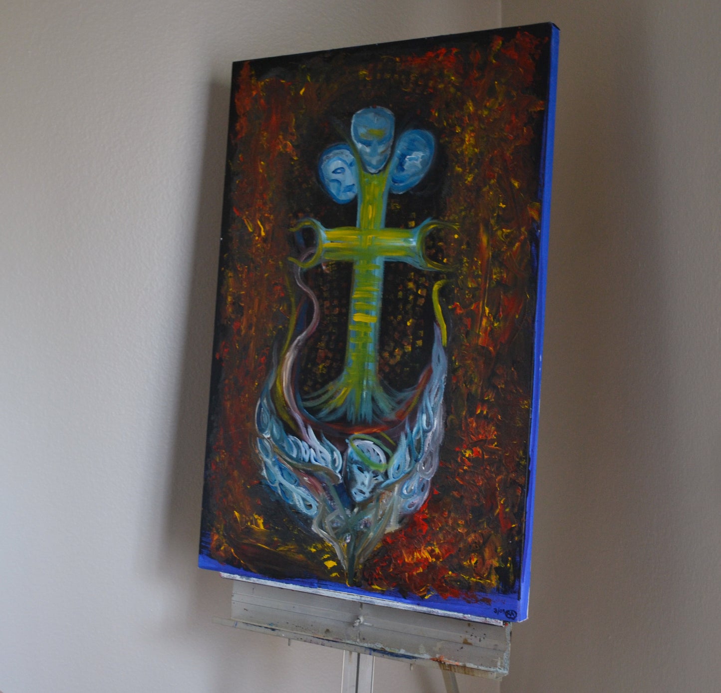 Angled view of ocean themed painting on metal easel.