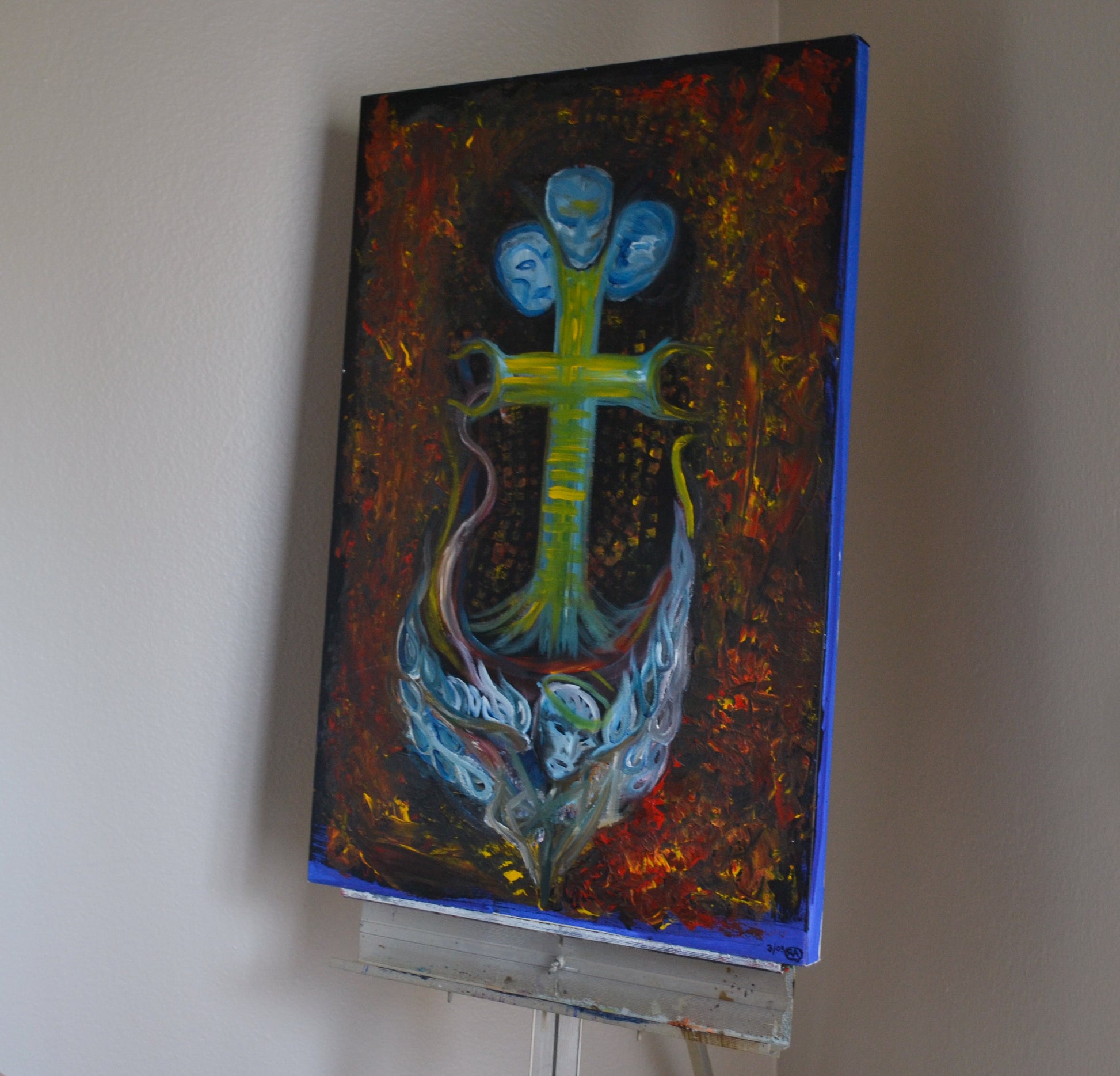 Angled view of ocean themed painting on metal easel.