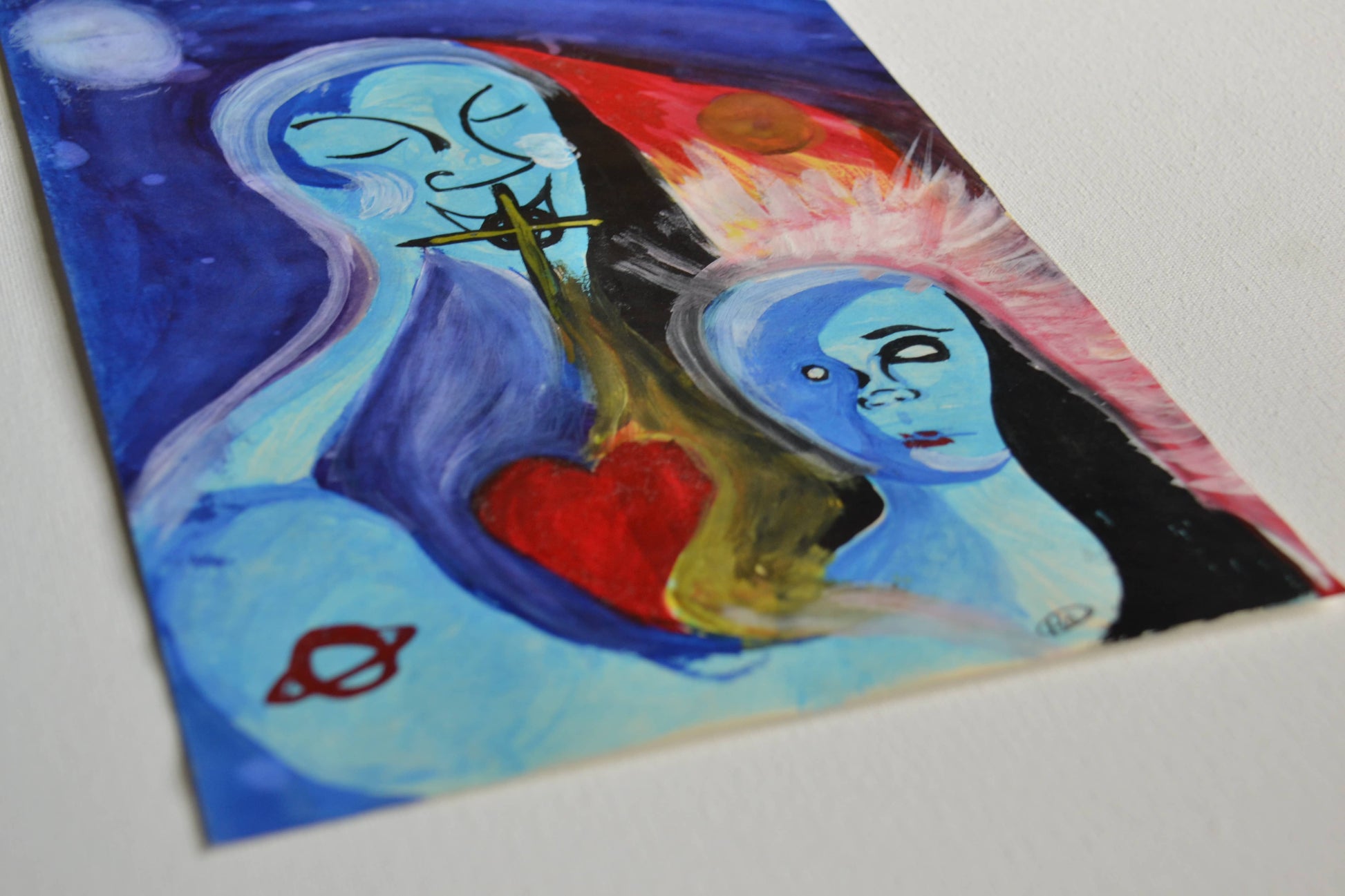 Angled view of two figures blue painting on white canvas.